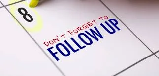Calendar with a highlighted date and a handwritten follow-up reminder